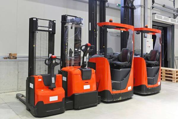 A forklift parked in front of a warehouse, highlighting its role in efficient cold storage and industrial logistics.