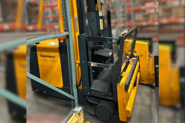 A Jungheinrich forklift parked in a warehouse, designed for narrow aisles with a compact and maneuverable structure.